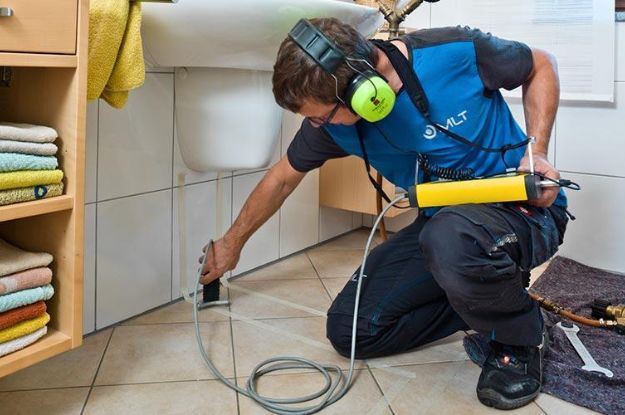 Rowlett technician uses advanced equipment to detect hidden leaks near a toilet, ensuring efficient and accurate plumbing diagnostics for homeowners in the United States. Location: Rowlett, United States